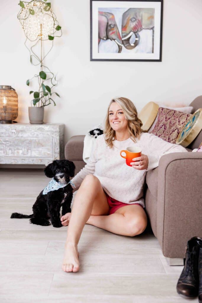 Kathryn CHivers relaxing with her two dogs and a cup of tea